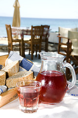 Image showing home made rose wine and crusty bread at greek island taverna