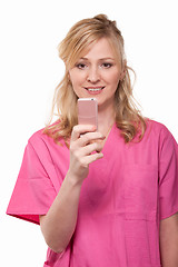 Image showing Nurse with pink cell phone