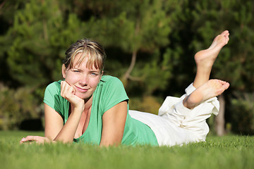 Image showing Woman relaxing on a lawn with a nice defocused background