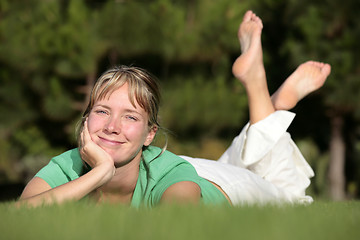 Image showing Woman relaxing on a lawn with a nice defocused background
