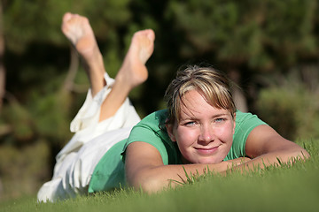 Image showing Woman relaxing on a lawn with a nice defocused background