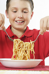 Image showing Child tossing pasta