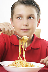 Image showing Child with forkful of noodles