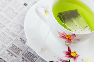 Image showing Green tea with newspaper