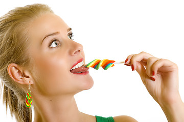Image showing closeup of an attractive woman biting a lolly pop