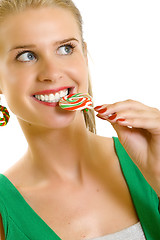 Image showing closeup of an attractive woman biting a lolly pop