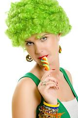 Image showing closeup of an attractive woman liking a lolly pop