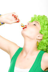 Image showing closeup of an attractive woman liking a lolly pop