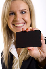 Image showing attractive businesswoman holding a blank card