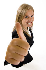 Image showing wide angle picture of an attractive businesswoman making her victory sign