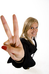 Image showing wide angle picture of an attractive businesswoman making her victory sign