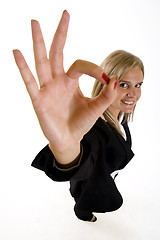 Image showing wide angle picture of an attractive businesswoman making her victory sign
