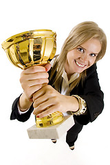 Image showing wide angle picture of an attractive businesswoman winning a gold cup