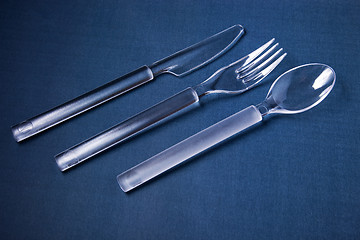 Image showing Plastic cover set on blue textile background