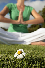 Image showing Woman Meditating with Blue Sky and Daisies