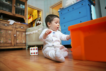 Image showing baby plays in the room, soft focus