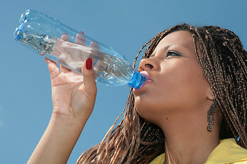 Image showing black african girl drinks a water