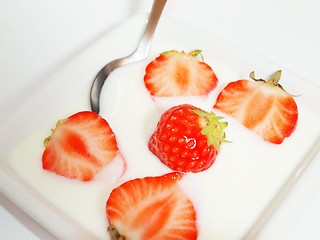 Image showing Strawberries in yogurt with a spoon