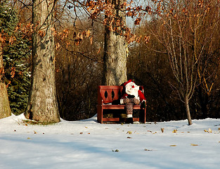 Image showing Santa on a Red Bench