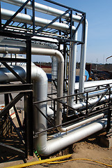 Image showing industrial pipelines on pipe-bridge against blue sky