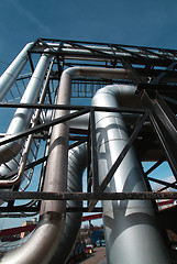 Image showing industrial pipelines on pipe-bridge against blue sky