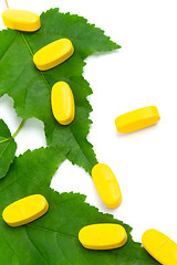 Image showing vitamin pills over green leaves