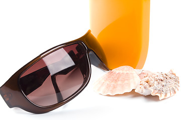 Image showing sunglasses, shells and lotion