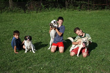 Image showing happy boy with dogs