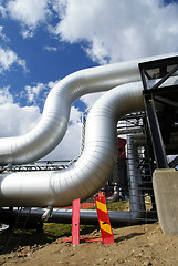 Image showing Pipes, bolts, valves against blue sky