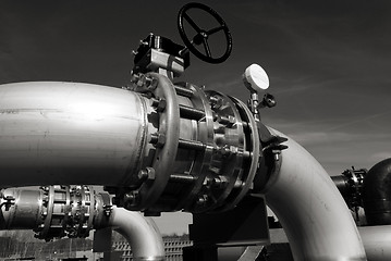 Image showing industrial pipelines on pipe-bridge against blue sky b&w 