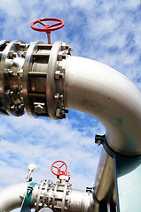 Image showing industrial pipelines on pipe-bridge against blue sky