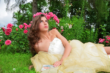 Image showing princess lying under rosebushes
