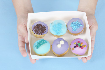 Image showing Hands holding cakes