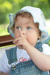 Image showing small girl with finger near face