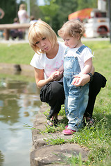 Image showing mother and small daughter near water