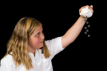 Image showing Child Emptying Piggy Bank