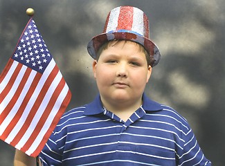 Image showing Young boy holding US FLag