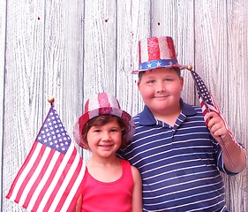 Image showing Young boy and girl with 4th of july hats on