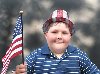 Image showing Young boy waving US Flag