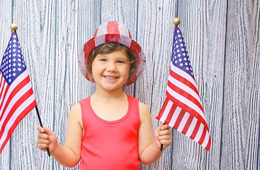 Image showing Pretty little girl waving two US Flags