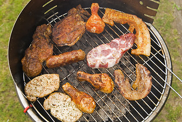 Image showing Sausages, beef and other meat on a barbecue