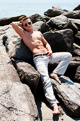 Image showing Toned man on rocks