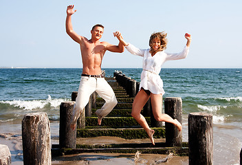 Image showing Happy couple jumping
