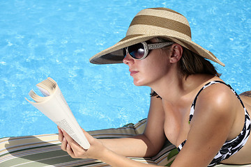 Image showing Reading by the Pool