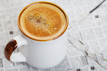 Image showing Coffee on a newspaper 