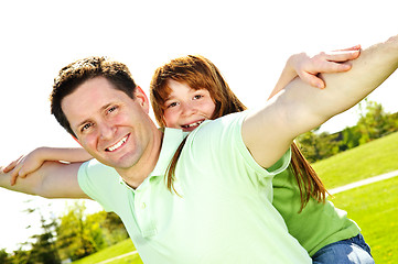 Image showing Father and daughter piggyback