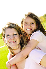 Image showing Mother and daughter piggyback