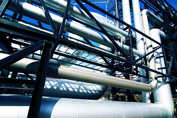 Image showing industrial pipelines on pipe-bridge against blue sky