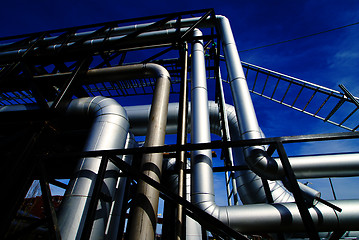 Image showing industrial pipelines on pipe-bridge against blue sky