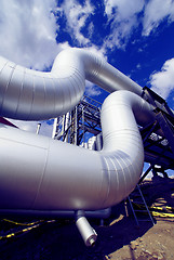 Image showing industrial pipelines on pipe-bridge against blue sky